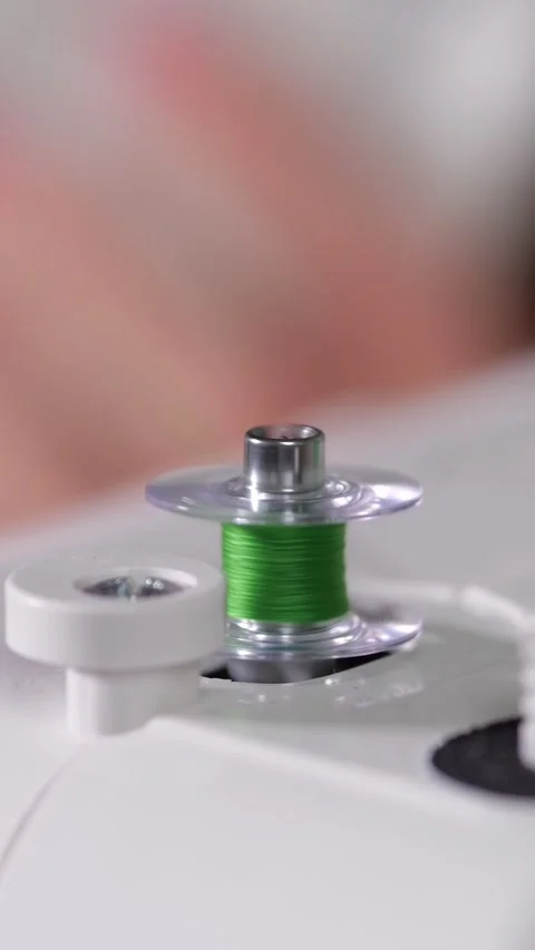 Green Thread Winds Onto Sewing Machine Bobbin During Mechanical Preparation Stock-Footage 347188498
