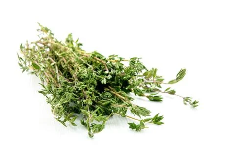 Green thyme herb branches on white wooden table background Stock Photos