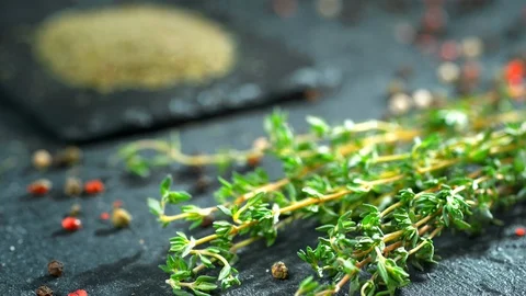 Green thyme slowly falls on the table Stock Footage