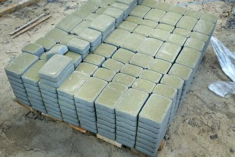 Green tile for the pavement folded into blocks. Stock Photos