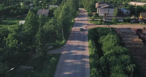 Green tiny car turning left in a small village Video stock 124620108