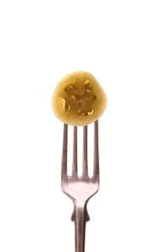Green tomato slice on fork, isolated Stock Photos