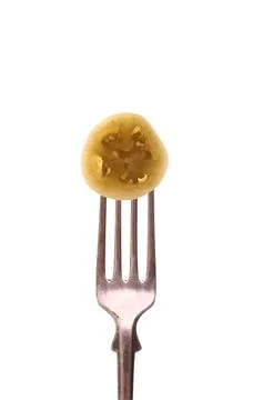 Green tomato slice on fork, isolated Green tomato slice on fork, isolated,... Stock Photos