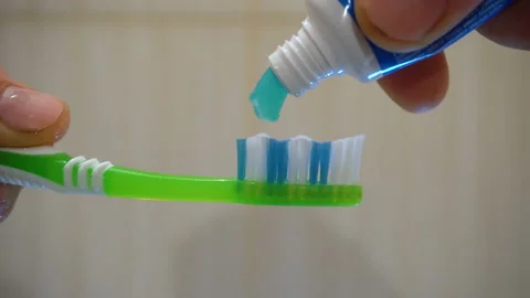 Green toothbrush and turquoise toothpaste 4K Stock Footage 147894787