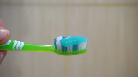 Green toothbrush with toothpaste 4K Stock Footage 147894789