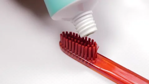 Green toothpaste and red toothbrush. Stock Footage 154458419