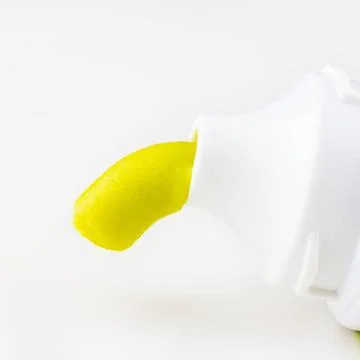 Green toothpaste is squeezed out of a tube of toothpaste on a white backgr... Stock Photos