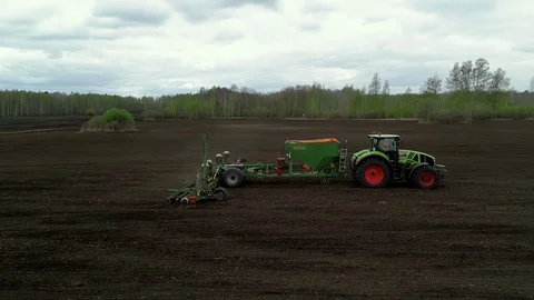 Green Tractor in Field With Sowing System Seeding Crops of Wheat, Vegetables. Stock Footage 127986617