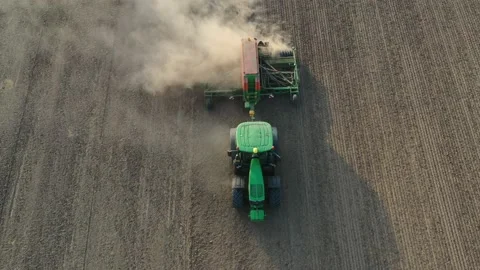 Green tractor plows a field Stock Footage 167099797