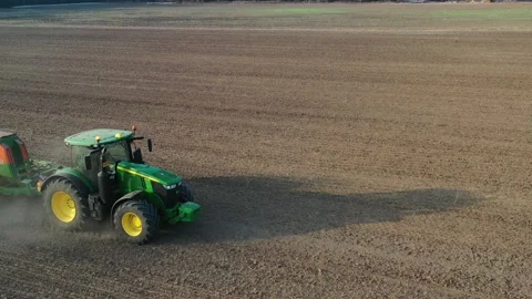 Green tractor plows a field - surround Stock Footage 167035149