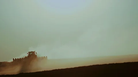 Green tractor with a seeder goes across the field, carried out by spring seeding Video stock 128366004