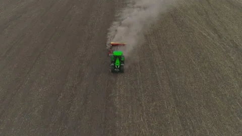 Green tractor seeding cereals or plowing arable land aerial. Stock Footage 167547983