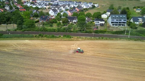 Green tractor working in a field Stock Footage 246671507
