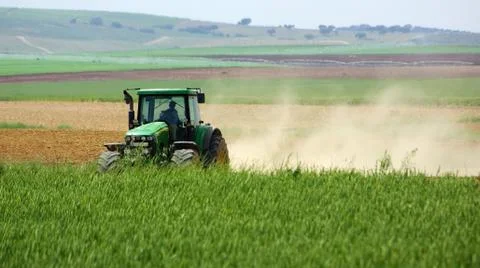 Green tractor working. Stock Photos
