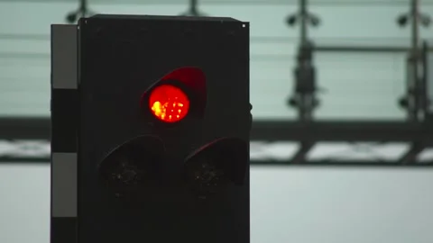 Green traffic light with blurred background, signaling go, changing to red Stock Footage 265572287