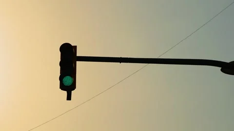 Green traffic light changing to red at urban intersection during sunset. Signal Stock Footage 342334341