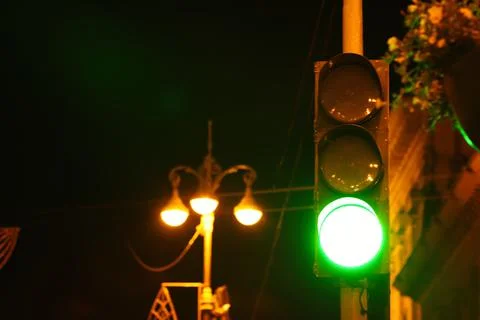 Green traffic light in city at night, space for text Stock Photos