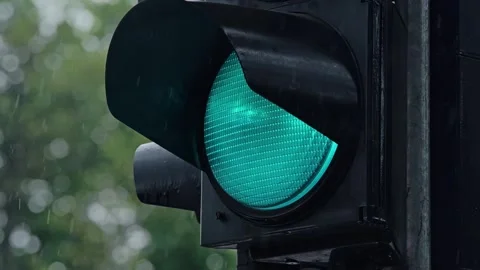Green Traffic Light Flickers In Heavy Rain While Water Drops Cover Signal Lens Stock Footage 346059795