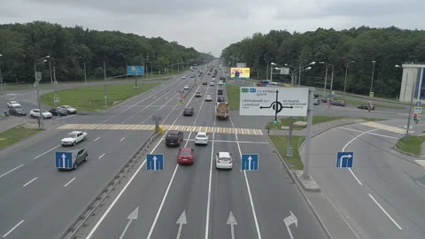 The green traffic light at the intersection with multi-lane traffic flashes. Stock Footage 100393419