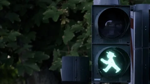 Green traffic light with man in hat symbol enhances safety on roads Stock Footage 264052078