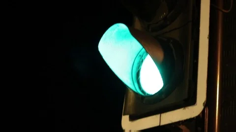 Green traffic light, pan down to red 'stop' man light at night, handheld Video stock 91623218