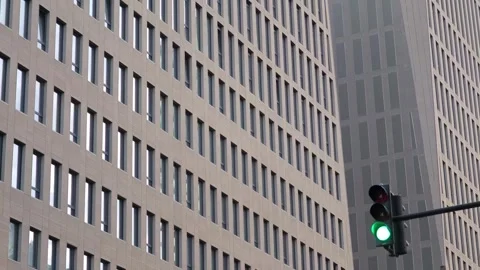 Green traffic light shining on modern building facade Stock-Footage 308036085