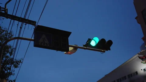 Green traffic light under blue sky with power lines Stock Footage 346212994
