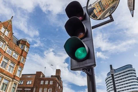 Green traffic light at urban intersection Stock Photos
