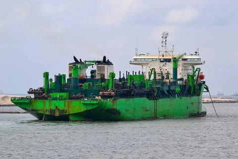 Green trailing suction hopper dredger working at sea Stock Photos