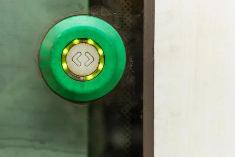 Green train door button in modern metro carriage close up Stock Photos