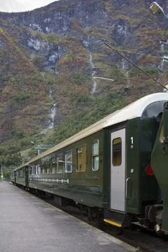 Green train in mountainous landscape Stock Photos