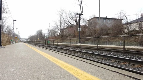Green Train passing train station platform Stock Footage 102762373