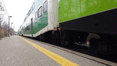Green Train stopping at train station platform Stock Footage 102757584