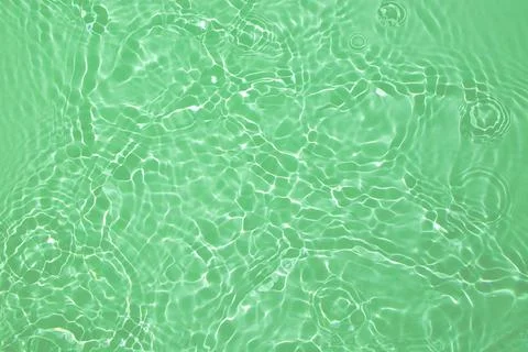 Green transparent clear water surface texture summer background Stock Photos