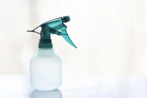 Green Transparent Spray Trigger Bottle on White Surface 写真素材