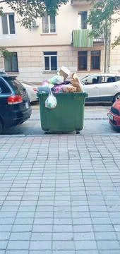 Green trash container with garbage Stock Photos