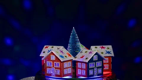 Green tree surrounded by five houses rotates on blue background Stock Footage 297744431