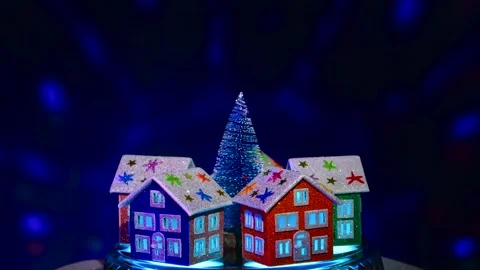 Green tree surrounded by five houses rotates on blue background Stock Footage 297746478