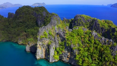Green trees covered mountains with lagoon on background blue sea in El Nido Stock Footage 107974990