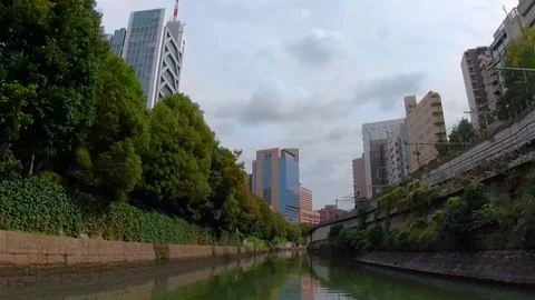 Green trees on the side of the canal wall in Osaka Japan Stock Footage 129278155