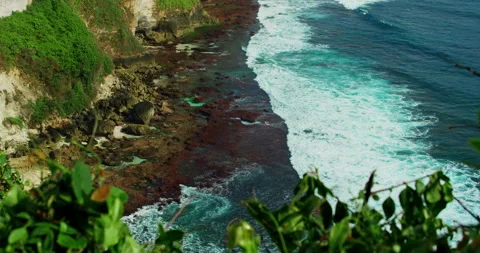 Green tropical cliffs washed by blue Indian Ocean waters with white foaming Video stock 226824668
