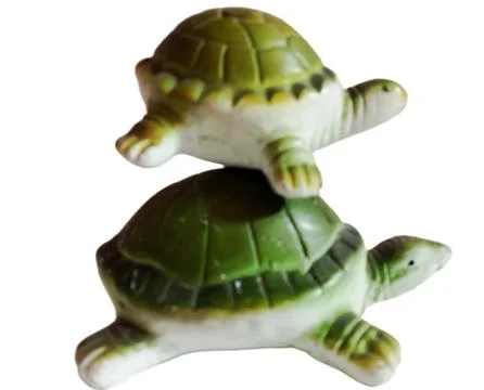 A green turtle statue on a green background Stock Photos