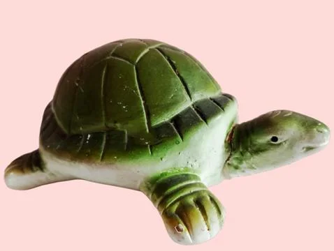 A green turtle statue on a white background Stock Photos