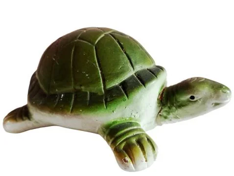 A green turtle statue on a white background. Stock Photos