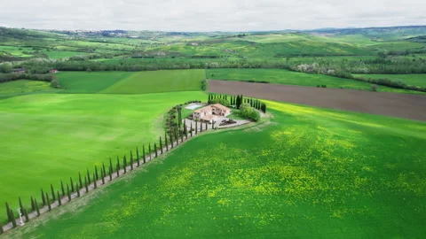 Green Tuscany fields during spring time drone footage Stock Footage 258457717