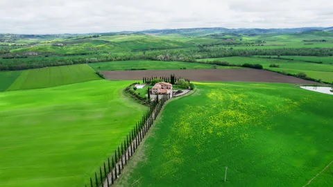 Green Tuscany fields during spring time drone footage Stock Footage 258457742