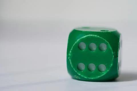 Green used dice Stock Photos