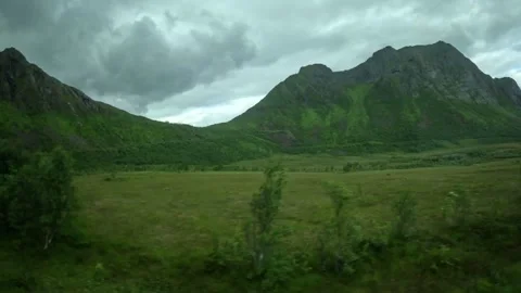 Green valley, birch trees, and dramatic mountain pass in Senja Norway Video stock 342340423