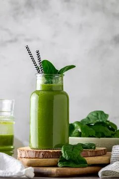 Green vegan healthy smoothie with fresh leaves Stock Photos