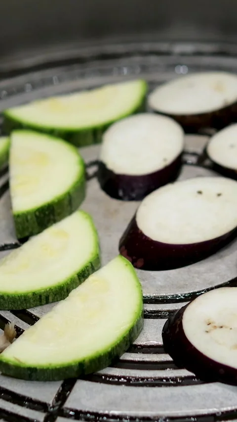 Green vegetable marrow or zucchini and eggplants are grilled over an open fire Stock Footage 302805165
